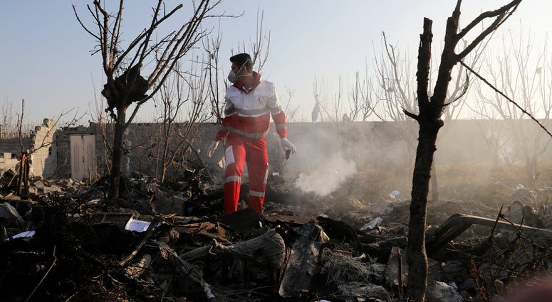 A rescue worker searches the scene where an Ukrainian plane crashed in Shahedshahr, southwest of the capital Tehran, Iran, Wednesday, Jan. 8, 2020. A rescue worker searches the scene where an Ukrainian plane crashed in Shahedshahr, southwest of the capital Tehran, Iran, Wednesday, Jan. 8, 2020.