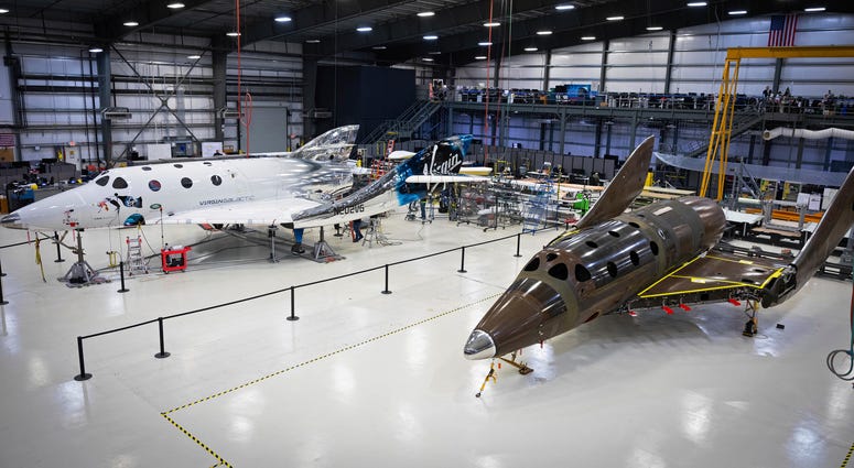 Virgin Galactic's next passenger spaceship, at right, stands on its landing gear in what is known as a weight-on-wheels test. Virgin Galactic's next passenger spaceship, at right, stands on its landing gear in what is known as a weight-on-wheels test.