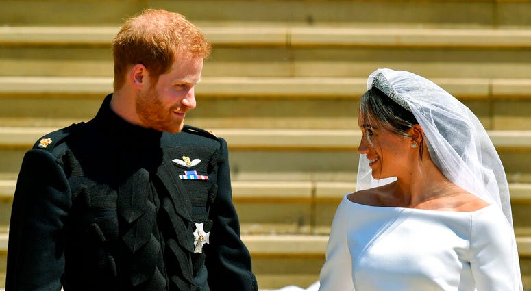 Britain's Prince Harry and Meghan Markle walk down the steps after their wedding at St. George's Chapel in Windsor Castle in Windsor, England. Britain's Prince Harry and Meghan Markle walk down the steps after their wedding at St. George's Chapel in Windsor Castle in Windsor, England.