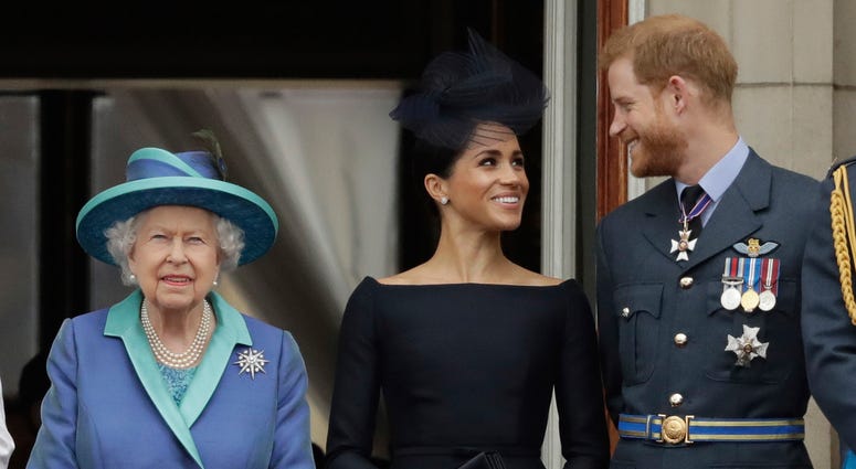 Britain's Queen Elizabeth II, and Meghan the Duchess of Sussex and Prince Harry watch a flypast of Royal Air Force aircraft pass over Buckingham Palace in London. Britain's Queen Elizabeth II, and Meghan the Duchess of Sussex and Prince Harry watch a flypast of Royal Air Force aircraft pass over Buckingham Palace in London.