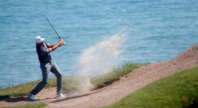 Dustin Johnson hits from a bunker on the third hole during the third round of the PGA Championship golf tournament at Whistling Straits in Haven, Wis. Dustin Johnson hits from a bunker on the third hole during the third round of the PGA Championship golf tournament at Whistling Straits in Haven, Wis.