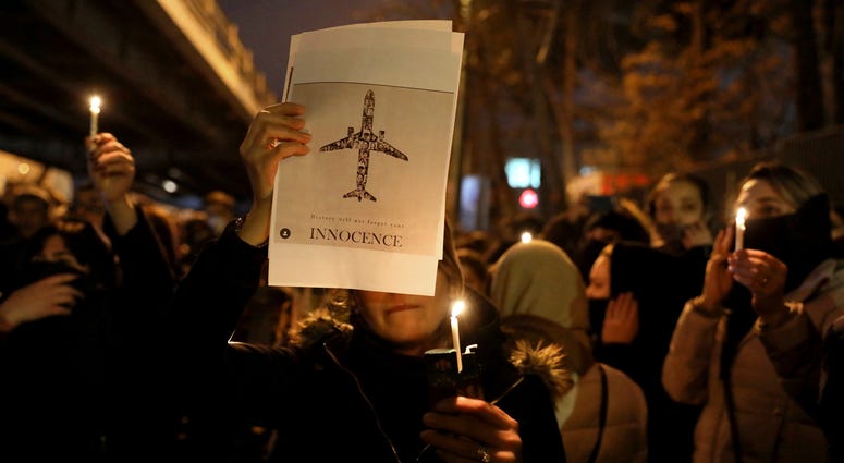 Iran on Saturday acknowledged that its armed forces "unintentionally" shot down the Ukrainian jetliner that crashed earlier this week, killing all 176 aboard, after the government had repeatedly denied Western accusations that it was responsible. People gather for a candlelight vigil to remember the victims of the Ukraine plane crash, at the gate of Amri Kabir University that some of the victims of the crash were former students of, in Tehran, Iran, Saturday.
