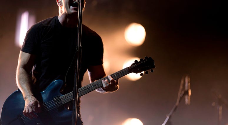 In this March 27, 2014 file photo, Trent Reznor of Nine Inch Nails performs at the Vive Latino music festival in Mexico City, Mexico. In this March 27, 2014 file photo, Trent Reznor of Nine Inch Nails performs at the Vive Latino music festival in Mexico City, Mexico.