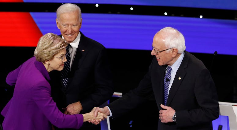 Democratic presidential candidates Sen. Elizabeth Warren, D-Mass., a1nd Sen. Bernie Sanders, I-Vt., talk Tuesday, Jan. 14, 2020, after a Democratic presidential primary debate in Des Moines, Iowa., as businessman Tom Steyer looks on. Democratic presidential candidates Sen. Elizabeth Warren, D-Mass., a1nd Sen. Bernie Sanders, I-Vt., talk Tuesday, Jan. 14, 2020, after a Democratic presidential primary debate in Des Moines, Iowa., as businessman Tom Steyer looks on.