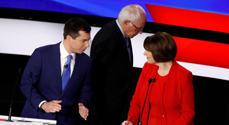 Democratic presidential candidates former South Bend Mayor Pete Buttigieg, left, and Sen. Amy Klobuchar, D-Minn., talk while Sen. Bernie Sanders, I-Vt., heads off stage at a break Tuesday, Jan. 14, 2020 Democratic presidential candidates former South Bend Mayor Pete Buttigieg, left, and Sen. Amy Klobuchar, D-Minn., talk while Sen. Bernie Sanders, I-Vt., heads off stage at a break Tuesday, Jan. 14, 2020