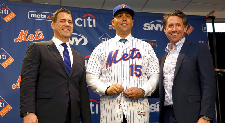 In this Nov. 4, 2019, file photo, new New York Mets manager, Carlos Beltran, center, poses for a picture with general manager Brodie Van Wagenen, left, and Mets COO Jeff Wilpon during a baseball news conference at Citi Field in New York. In this Nov. 4, 2019, file photo, new New York Mets manager, Carlos Beltran, center, poses for a picture with general manager Brodie Van Wagenen, left, and Mets COO Jeff Wilpon during a baseball news conference at Citi Field in New York.