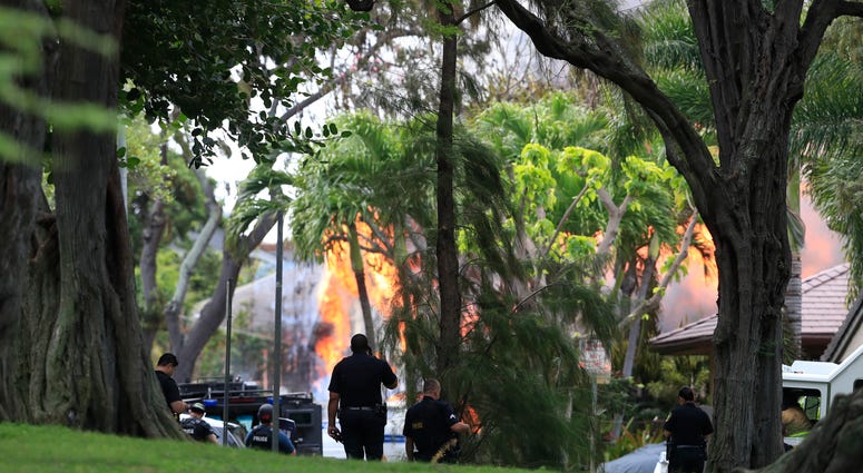Witnesses say at least two Honolulu police officers were shot and two civilians were injured. Moments after the shooting, the house was set on fire, possibly by the suspect. Honolulu police watch a house fire after a shooting and domestic incident at a residence on Hibiscus Road near Diamond Head on Sunday, Jan. 19, 2020, in Honolulu.