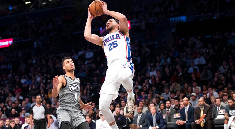 Philadelphia 76ers guard Ben Simmons (25) goes to the basket past Brooklyn Nets guard Chris Chiozza (9) during the first half of an NBA basketball game, Monday, Jan. 20, 2020, in New York. Philadelphia 76ers guard Ben Simmons (25) goes to the basket past Brooklyn Nets guard Chris Chiozza (9) during the first half of an NBA basketball game, Monday, Jan. 20, 2020, in New York.