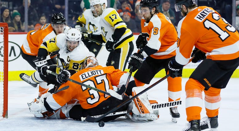 Pittsburgh Penguins' Sidney Crosby (87) tries to get a shot past Philadelphia Flyers' Brian Elliott (37) as Philippe Myers (5), Ivan Provorov (9) and Kevin Hayes (13) defend during the third period of an NHL hockey game, Tuesday, Jan. 21, 2020. Pittsburgh Penguins' Sidney Crosby (87) tries to get a shot past Philadelphia Flyers' Brian Elliott (37) as Philippe Myers (5), Ivan Provorov (9) and Kevin Hayes (13) defend during the third period of an NHL hockey game, Tuesday, Jan. 21, 2020.