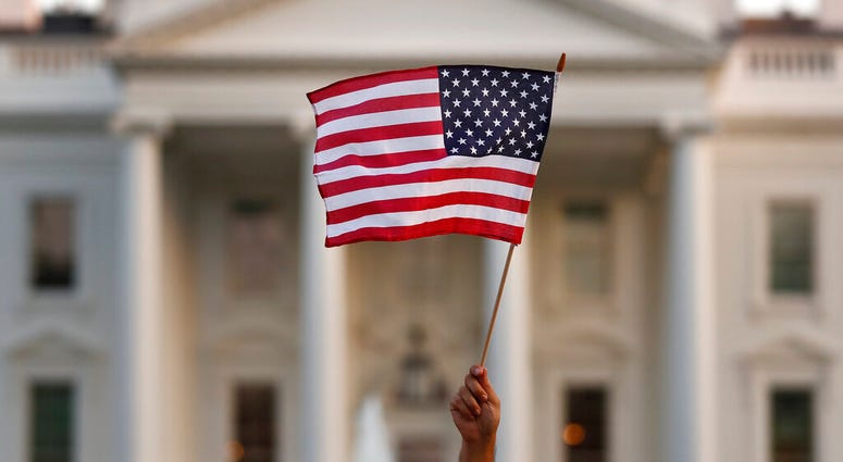 FILE - In this Sept. 2017 file photo, a flag is waved outside the White House, in Washington. A flag is waved outside the White House, in Washington.