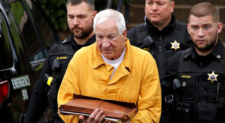 In this Nov. 22, 2019, file photo, former Penn State University assistant football coach Jerry Sandusky, center, arrives at the Centre County Courthouse to be resentenced in Bellefonte, Pa. In this Nov. 22, 2019, file photo, former Penn State University assistant football coach Jerry Sandusky, center, arrives at the Centre County Courthouse to be resentenced in Bellefonte, Pa.