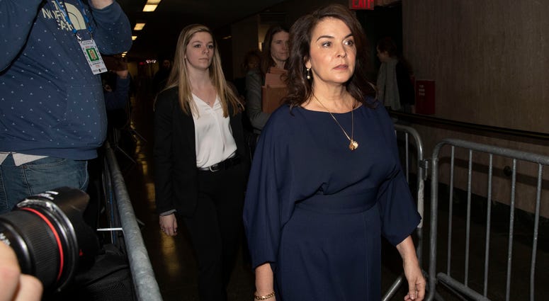 Actress Annabella Sciorra, right, arrives as a witness in Harvey Weinstein's rape trial, in New York, Thursday, Jan. 23, 2020. Actress Annabella Sciorra arrives as a witness in Harvey Weinstein's rape trial.