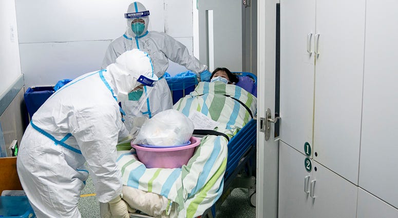 Medical workers transfer a patient out of the intensive care unit at Zhongnan Hospital of Wuhan University in Wuhan in central China's Hubei Province on Friday, Jan. 24, 2020. Medical workers transfer a patient out of the intensive care unit at Zhongnan Hospital of Wuhan University in Wuhan in central China's Hubei Province on Friday, Jan. 24, 2020.
