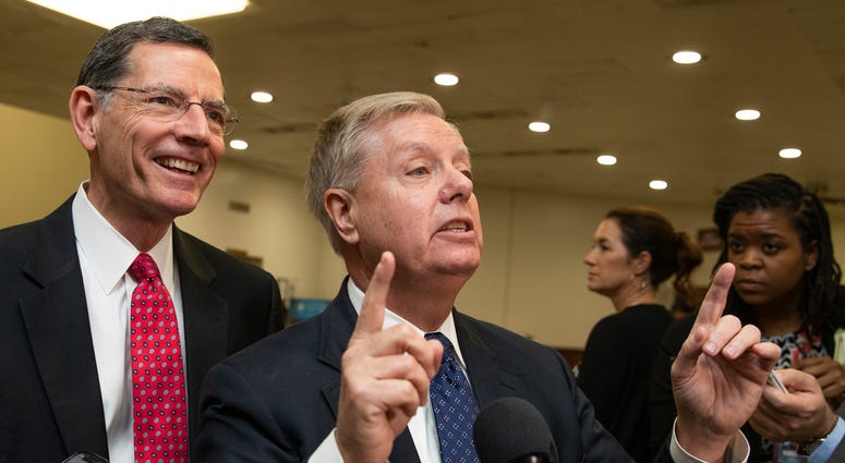 Sen. Lindsey Graham, R-S.C., with Sen. John Barrasso, R-Wyo., speaks to reporters on Capitol Hill in Washington, Saturday, Jan. 25, 2020. Sen. Lindsey Graham, R-S.C., with Sen. John Barrasso, R-Wyo., speaks to reporters on Capitol Hill in Washington, Saturday, Jan. 25, 2020.