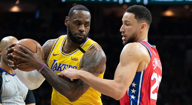 Los Angeles Lakers' LeBron James, left, tries to make his move on Philadelphia 76ers' Ben Simmons, right, during the first half of an NBA basketball game, Saturday, Jan. 25, 2020, in Philadelphia. Los Angeles Lakers' LeBron James, left, tries to make his move on Philadelphia 76ers' Ben Simmons, right, during the first half of an NBA basketball game, Saturday, Jan. 25, 2020, in Philadelphia.