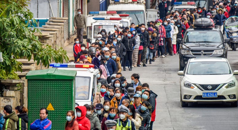 In this Jan. 29, 2020 photo, people line up to buy face masks from a medical supply company in Nanning in southern China's Guangxi Zhuang Autonomous Region. In this Jan. 29, 2020 photo, people line up to buy face masks from a medical supply company in Nanning in southern China's Guangxi Zhuang Autonomous Region.