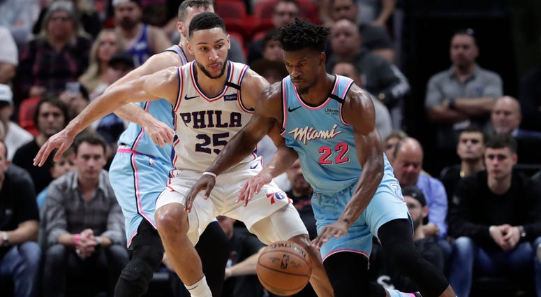 Miami Heat forward Jimmy Butler (22) drives to the basket as Philadelphia 76ers guard Ben Simmons (25) defends during the first half of an NBA basketball game, Monday, Feb. 3, 2020, in Miami. Miami Heat forward Jimmy Butler (22) drives to the basket as Philadelphia 76ers guard Ben Simmons (25) defends during the first half of an NBA basketball game, Monday, Feb. 3, 2020, in Miami.