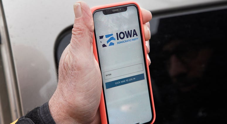 Precinct captain Carl Voss of Des Moines displays the Iowa Democratic Party caucus reporting app on his phone outside of the Iowa Democratic Party headquarters in Des Moines, Iowa, Tuesday, Feb. 4, 2020. Iowa Democratic Party caucus