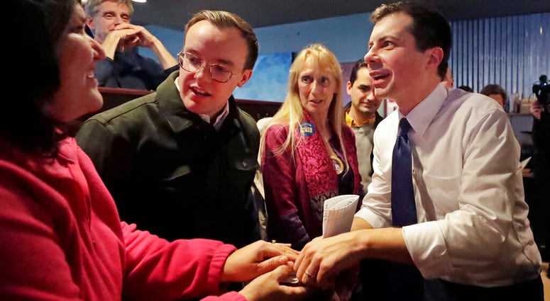 Democratic presidential candidate former South Bend Mayor Pete Buttigieg, right, and his husband, Chasten Buttigieg, left, greet people at a campaign event, Tuesday, Feb. 4, 2020, in Hampton, N.H. Democratic presidential candidate former South Bend Mayor Pete Buttigieg, right, and his husband, Chasten Buttigieg, left, greet people at a campaign event, Tuesday, Feb. 4, 2020, in Hampton, N.H.