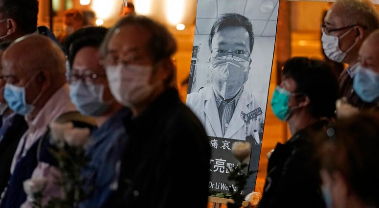 People wearing masks, attend a vigil for Chinese doctor Li Wenliang, in Hong Kong, Friday, Feb. 7, 2020. People wearing masks, attend a vigil for Chinese doctor Li Wenliang, in Hong Kong, Friday, Feb. 7, 2020.