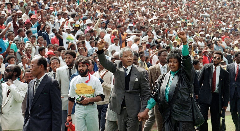 Nelson Mandela and his wife, Winnie Madikizela-Mandela, gesture as they arrive at Soccer City Stadium in Soweto, South Africam on Feb. 13, 1990, two days after after being released from prison after serving 27 years. Nelson Mandela and his wife, Winnie Madikizela-Mandela, gesture as they arrive at Soccer City Stadium in Soweto, South Africam on Feb. 13, 1990, two days after after being released from prison after serving 27 years.