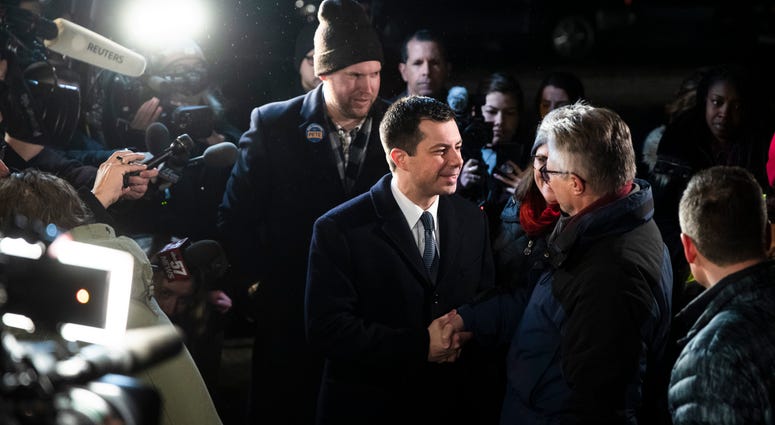 Democratic presidential candidate former South Bend, Ind., Mayor Pete Buttigieg meets with voters outside a polling place before they cast their ballots in a primary election, Tuesday, Feb. 11, 2020, in Manchester, N.H. Democratic presidential candidate former South Bend, Ind., Mayor Pete Buttigieg meets with voters outside a polling place before they cast their ballots in a primary election, Tuesday, Feb. 11, 2020, in Manchester, N.H.