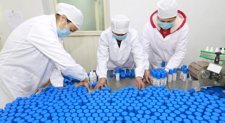 Workers pack bottles of alcohol disinfectant in a factory in Suining in southwest China's Sichuan province Tuesday, Feb. 11, 2020. Workers pack bottles of alcohol disinfectant in a factory in Suining in southwest China's Sichuan province Tuesday, Feb. 11, 2020.