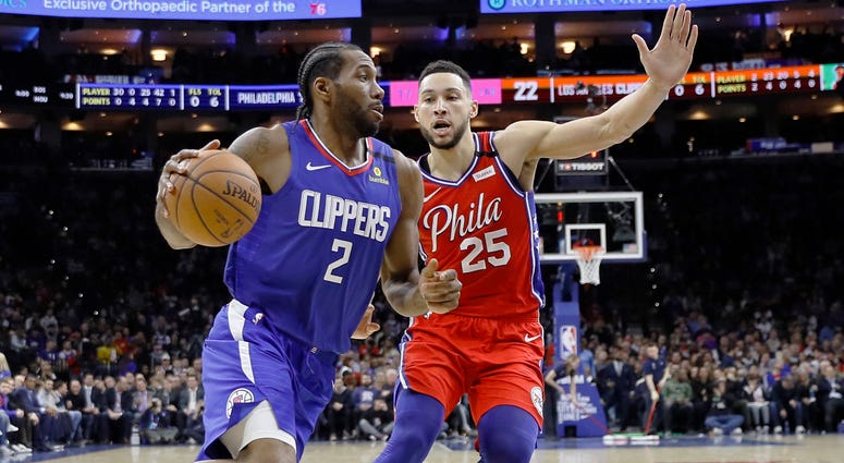 Los Angeles Clippers' Kawhi Leonard, left, drives past Philadelphia 76ers' Ben Simmons during the first half of an NBA basketball game, Tuesday, Feb. 11, 2020, in Philadelphia. Los Angeles Clippers' Kawhi Leonard, left, drives past Philadelphia 76ers' Ben Simmons during the first half of an NBA basketball game, Tuesday, Feb. 11, 2020, in Philadelphia.