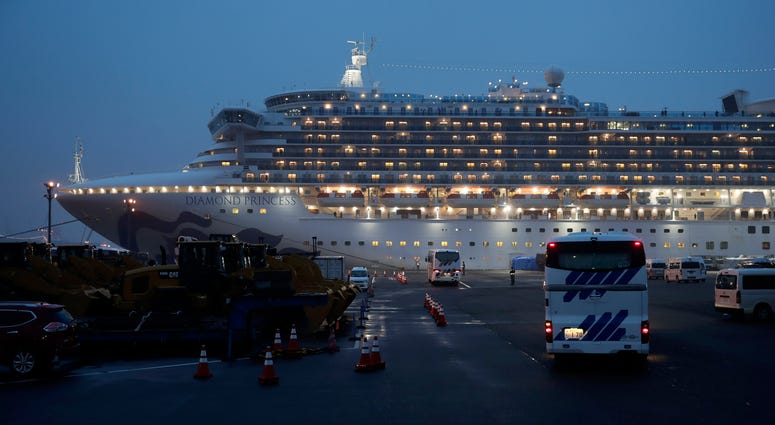 The U.S. says Americans aboard a quarantined ship will be flown back home on a chartered flight Sunday, but that they will face another two-week quarantine. Buses arrive at a port as the Japan Self-Defense Forces prepare to move American passengers from the quarantined Diamond Princess cruise ship Sunday, Feb. 16, 2020, at Yokohama Port, near Tokyo.
