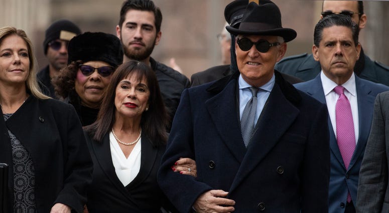 Roger Stone with accompanied by his wife Nydia Stone, second from left, arrives at federal court in Washington, Thursday, Feb. 20, 2020. Roger Stone