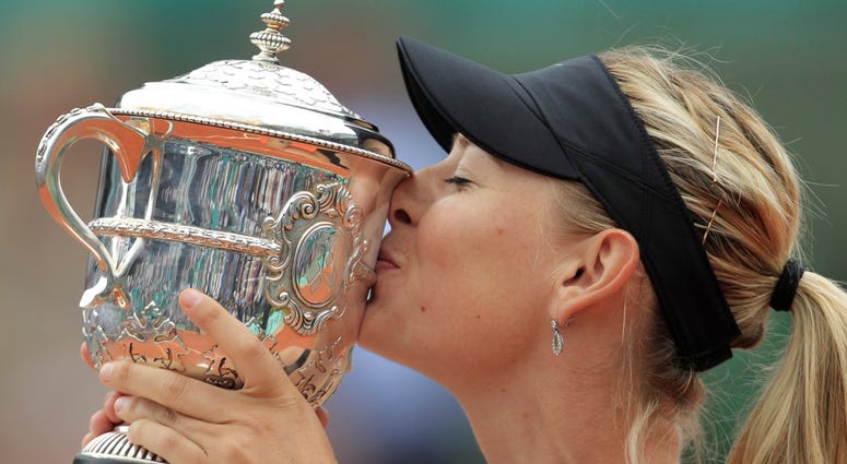 In this June 9, 2012, file photo, Maria Sharapova of Russia holds the trophy after winning the women's final match against Sara Errani of Italy at the French Open tennis tournament at Roland Garros stadium in Paris. Maria Sharapova