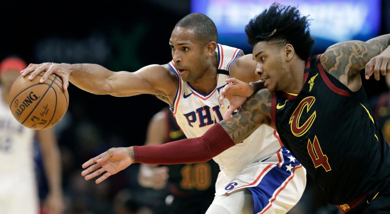 Philadelphia 76ers' Al Horford, left, and Cleveland Cavaliers' Kevin Porter Jr. battle for a loose ball in the first half of an NBA basketball game, Wednesday, Feb. 26, 2020, in Cleveland. Philadelphia 76ers' Al Horford, left, and Cleveland Cavaliers' Kevin Porter Jr. battle for a loose ball in the first half of an NBA basketball game, Wednesday, Feb. 26, 2020, in Cleveland.