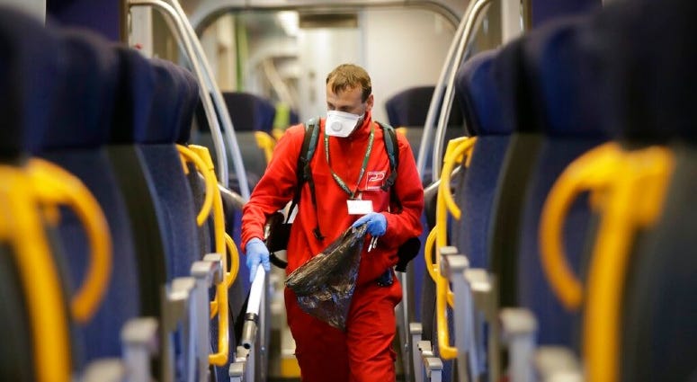 A cleaner sanitizes a wagon on a regional train, at the Garibaldi train station in Milan, Italy, Friday, Feb. 28, 2020. A cleaner sanitizes a wagon on a regional train, at the Garibaldi train station in Milan, Italy, Friday, Feb. 28, 2020.