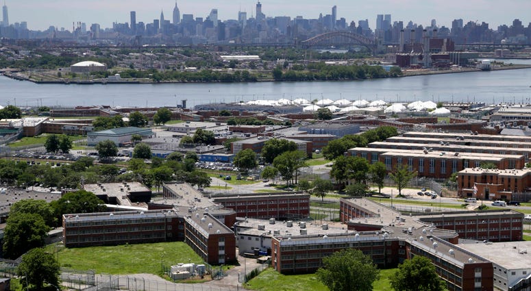 The Rikers Island jail complex stands in New York with the Manhattan skyline in the background, June 20, 2014. Rikers Island jail complex