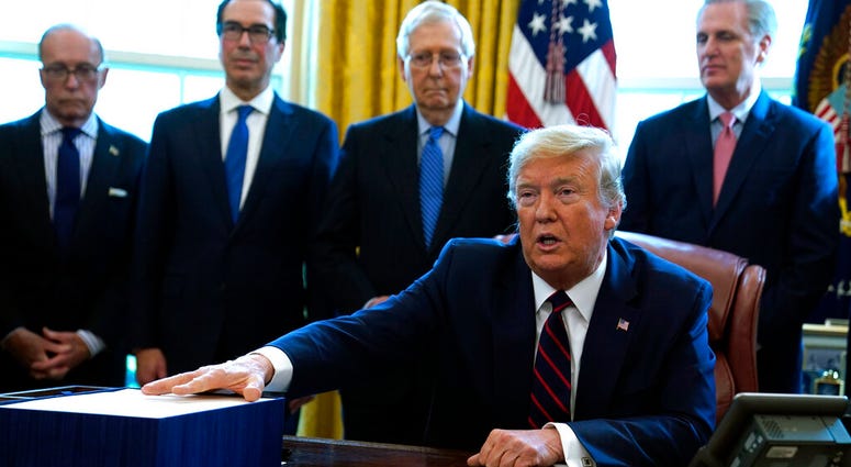 President Donald Trump speaks before he signs the coronavirus stimulus relief package in the Oval Office at the White House, Friday, March 27, 2020, in Washington. President Donald Trump speaks before he signs the coronavirus stimulus relief package in the Oval Office at the White House, Friday, March 27, 2020, in Washington.