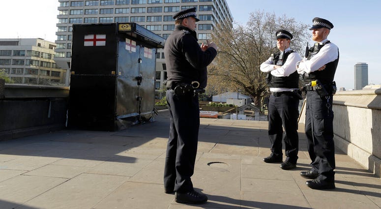 Police officers stand outside St Thomas' Hospital in central London as British Prime Minister Boris Johnson was moved to intensive care after his coronavirus symptoms worsened in London, Tuesday, April 7, 2020. Police officers stand outside St Thomas' Hospital in central London as British Prime Minister Boris Johnson was moved to intensive care after his coronavirus symptoms worsened in London, Tuesday, April 7, 2020.