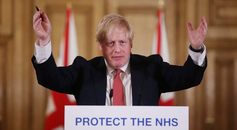 The British prime minister's office says Boris Johnson will return to work Monday April 27, 2020, two weeks after he was discharged from a London hospital where he was treated for the coronavirus. In this Sunday March 22, 2020 file photo British Prime Minister Boris Johnson gestures during his daily COVID 19 coronavirus press briefing to announce new measures to limit the spread of the virus.