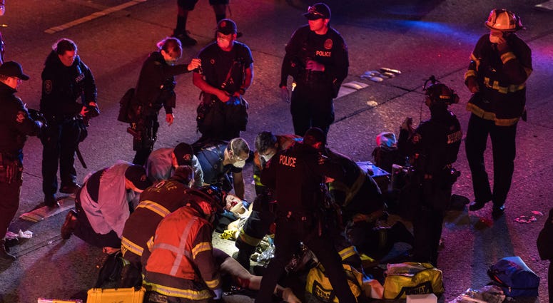 Dawit Kelete, 27, has been arrested and booked on two counts of vehicular assault. Emergency workers tend to an injured person on the ground after a driver sped through a protest-related closure on the Interstate 5 freeway in Seattle, authorities said early Saturday, July 4, 2020.