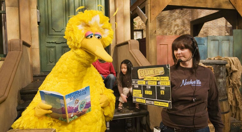 In this April 10, 2008, file photo Lynn Finkel, stage manager for "Sesame Street" slates a taping with Big Bird in New York. In this April 10, 2008, file photo Lynn Finkel, stage manager for "Sesame Street" slates a taping with Big Bird in New York.