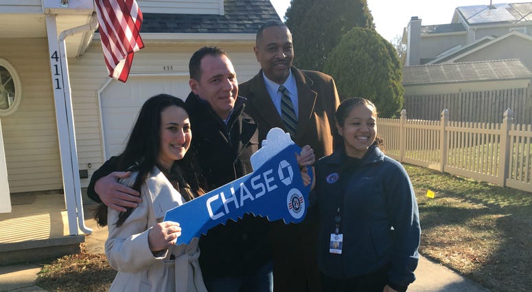 Brett Dawson, with his fiancée at far left, stands with representatives from J.P. Morgan Chase and Operation Homefront. Brett Dawson, with his fiancée at far left, stands with representatives from J.P. Morgan Chase and Operation Homefront.
