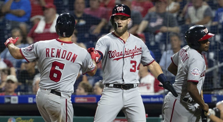 Washington Nationals' Bryce Harper, center, celebrates with Anthony Rendon, left, on his two-run home run during the ninth inning of a baseball game against the Philadelphia Phillies, Tuesday, Aug. 28, 2018, in Philadelphia. Washington Nationals' Bryce Harper, center, celebrates with Anthony Rendon, left, on his two-run home run during the ninth inning of a baseball game against the Philadelphia Phillies, Tuesday, Aug. 28, 2018, in Philadelphia.