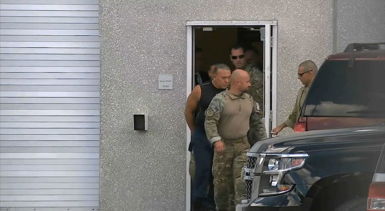 This frame grab from video provided by WPLG-TV shows FBI agents escorting Cesar Sayoc, in sleeveless shirt, in Miramar, Fla., on Friday, Oct. 26, 2018. This frame grab from video provided by WPLG-TV shows FBI agents escorting Cesar Sayoc, in sleeveless shirt, in Miramar, Fla., on Friday, Oct. 26, 2018.