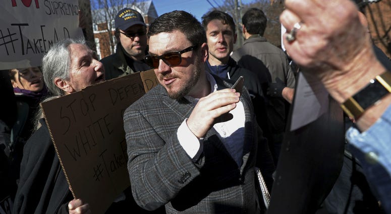 In this Feb. 27, 2018, file photo, Jason Kessler walks through a crowd of protesters in front of the Charlottesville Circuit Courthouse ahead of a decision regarding the covered Confederate statues, during a rally in Charlottesville, Va. In this Feb. 27, 2018, file photo, Jason Kessler walks through a crowd of protesters in front of the Charlottesville Circuit Courthouse ahead of a decision regarding the covered Confederate statues, during a rally in Charlottesville, Va.