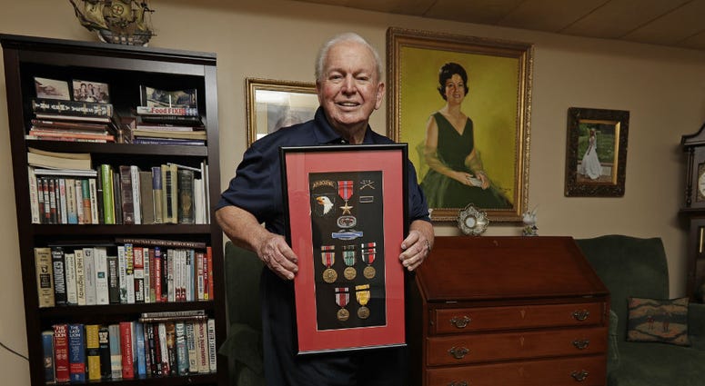 In this Wednesday, May 22, 2019, photo, D-Day veteran Eugene Deibler poses for a photo with his medals from WWII at his home in Charlotte, N.C. In this Wednesday, May 22, 2019, photo, D-Day veteran Eugene Deibler poses for a photo with his medals from WWII at his home in Charlotte, N.C.