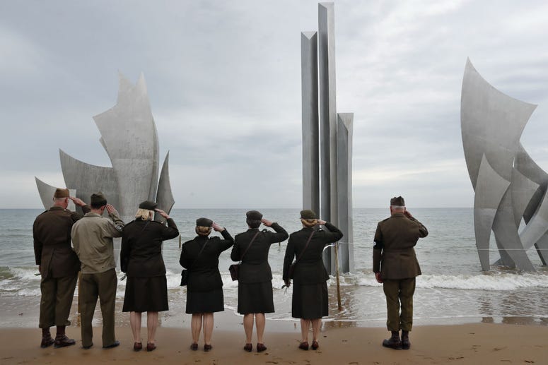 Enthusiasts of England salute in front of The Brave, a monument dedicated to the American soldiers who landed on Omaha Beach on D-Day, in Saint-Laurent-sur-Mer, Tuesday, June 4, 2019, in Normandy. Enthusiasts of England salute in front of The Brave, a monument dedicated to the American soldiers who landed on Omaha Beach on D-Day, in Saint-Laurent-sur-Mer, Tuesday, June 4, 2019, in Normandy.