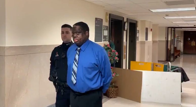 Lawrence Crawley is escorted by police to his murder trial on Jan. 14, 2020. Lawrence Crawley