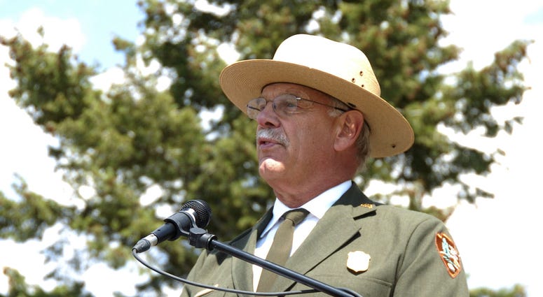 This August 17, 2017 file photo shows Yellowstone Superintendent Dan Wenk speaking at an event marking a conservation agreement for a former mining site just north of the park in Jardine, Mont. Yellowstone Superintendent Dan Wenk
