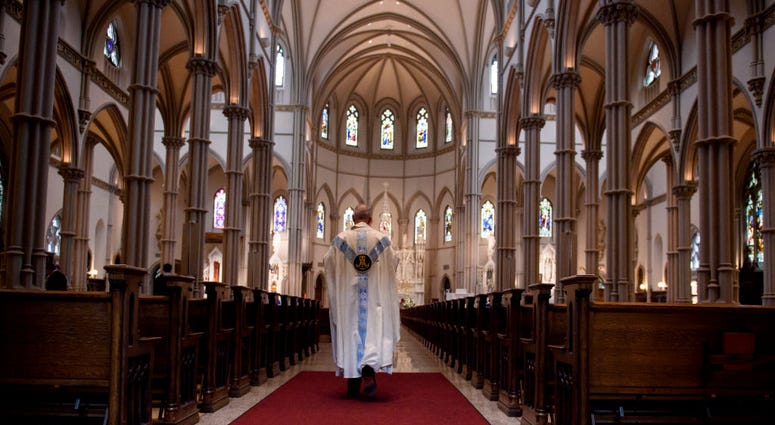 Father Kris Stubna walks to the sanctuary following a mass to celebrate the Assumption of the Blessed Virgin Mary at St. Paul Cathedral, the mother church of the Pittsburgh Diocese on Aug. 15, 2018 in Pittsburgh, Pennsylvania. St. Paul Cathedral, the mother church of the Pittsburgh Diocese