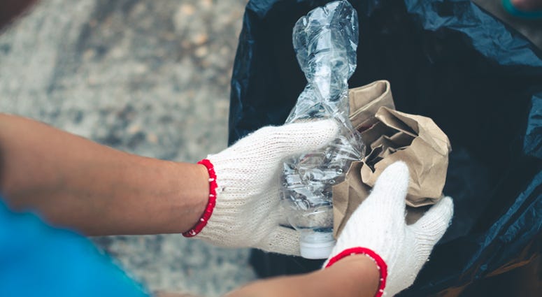 Person picking up trash. Person picking up trash.