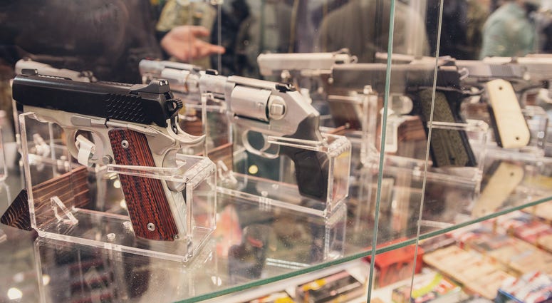 Guns on a show-window of shop. Gun Shop